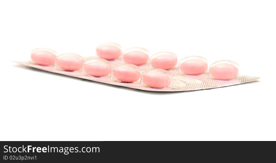 White round pills on the white isolated background