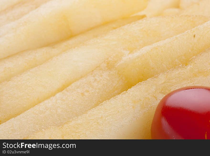 Ripe tomato in a plate with a fried potato.