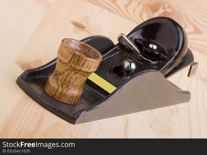 Woodworking handplane on a piece of wood.