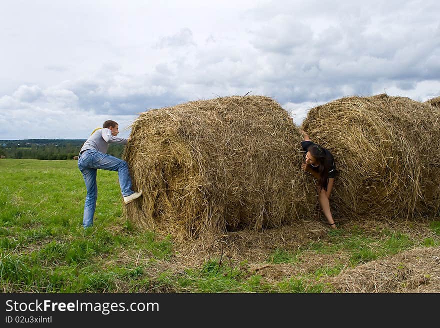 Young couple costs about a haystack