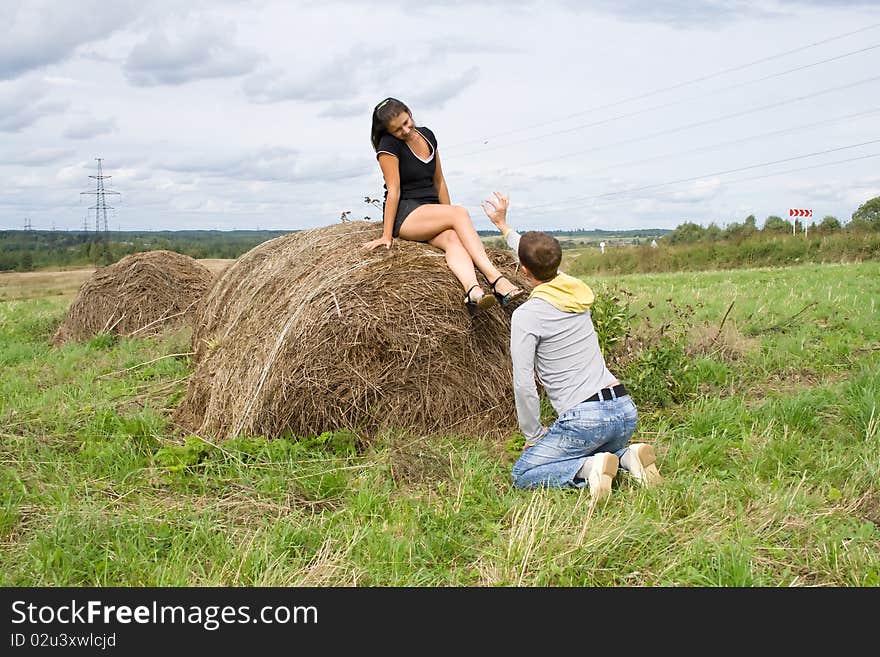 Young couple costs about a haystack