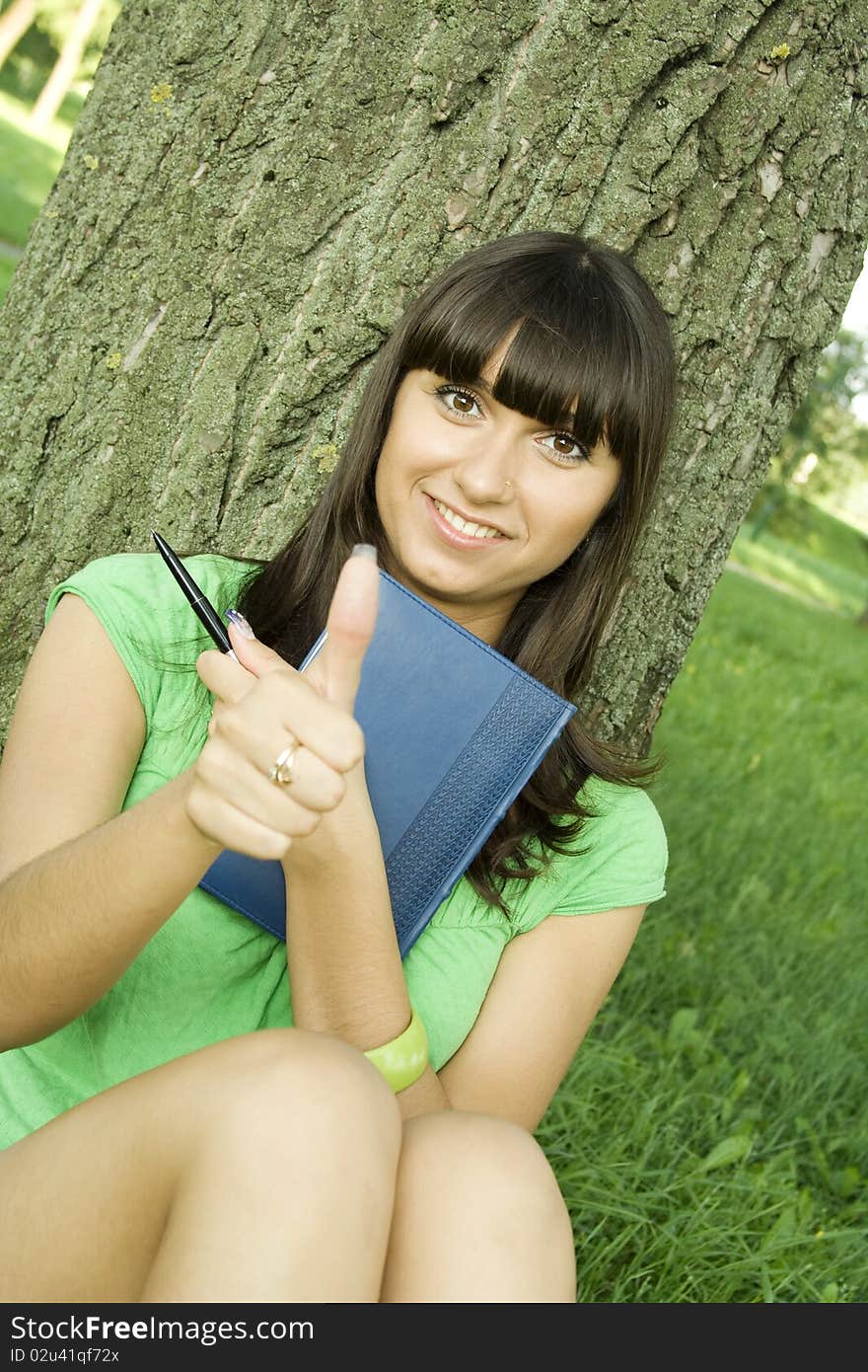 Female in a park with a notebook