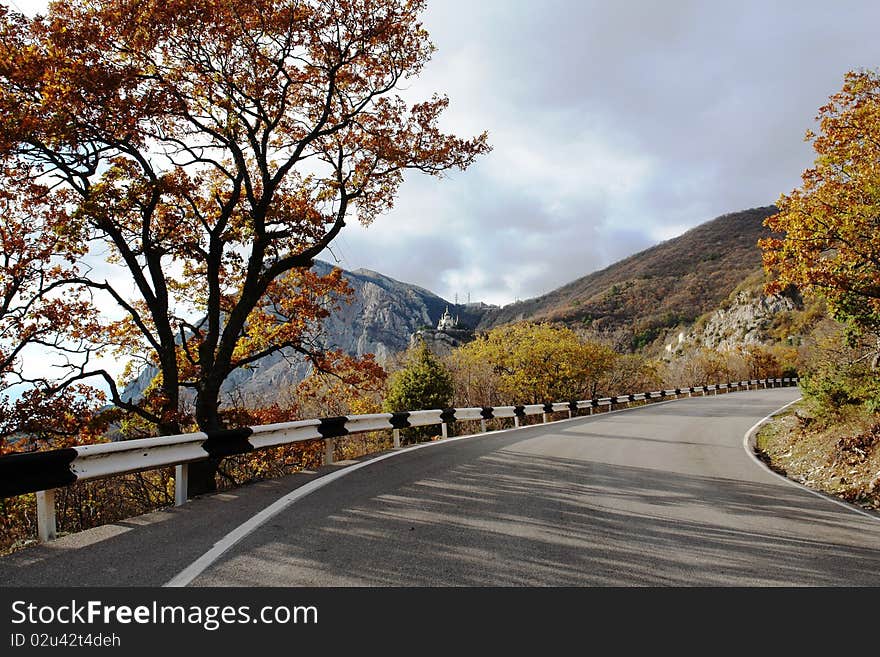 The road in mountains autumn yellow foliage