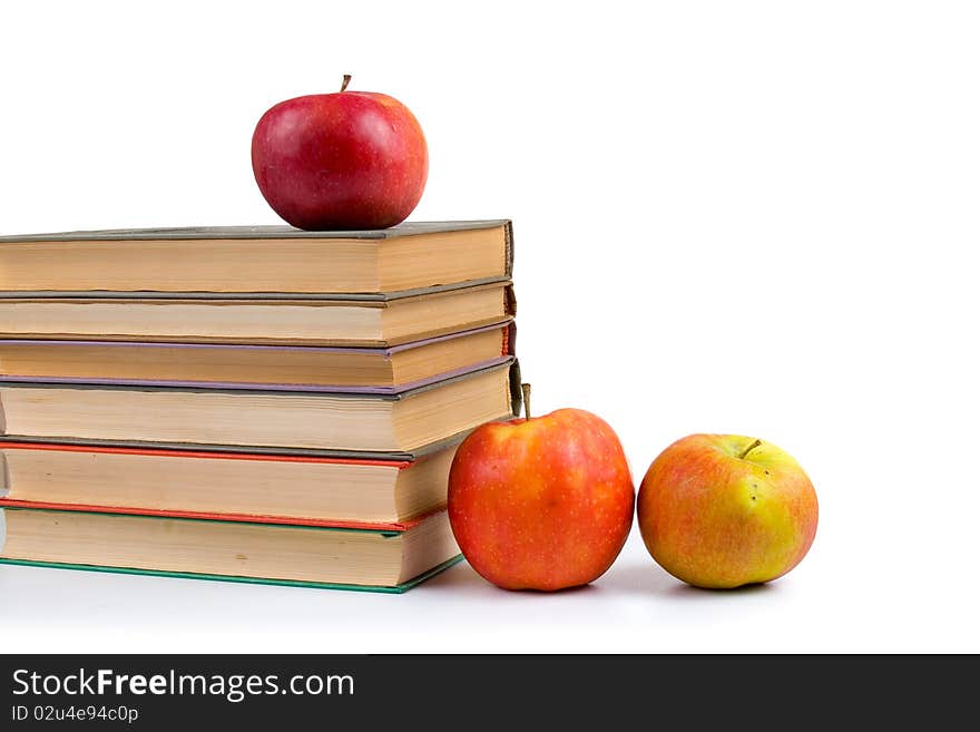 Apples and books isolated on a white background