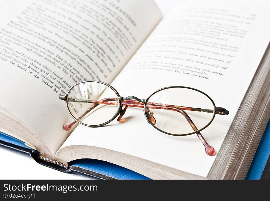 A book with old eye glass. A book with old eye glass