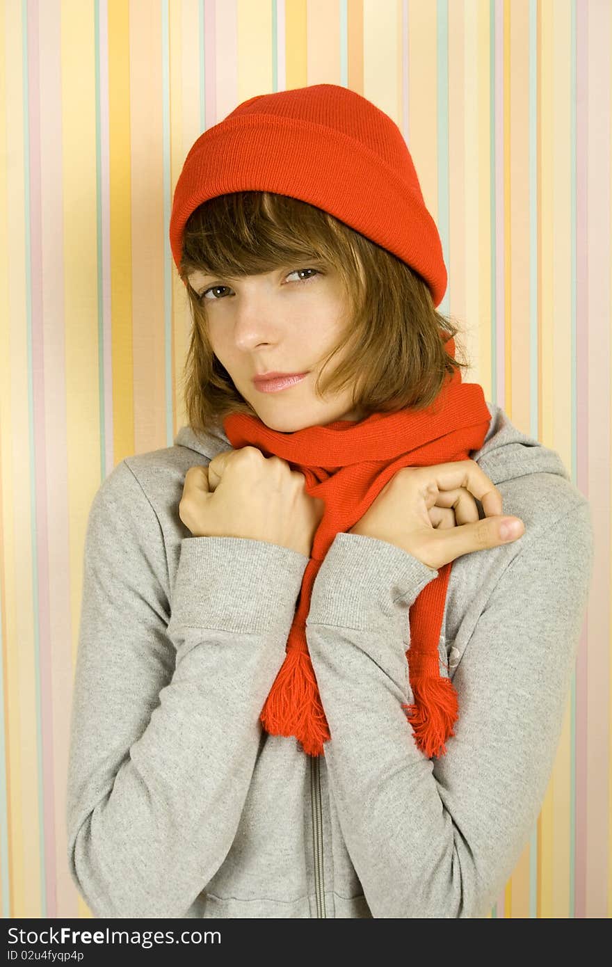 Photo of a young woman in a gray bike with a red knitted hat and scarf. Freezes. Photo of a young woman in a gray bike with a red knitted hat and scarf. Freezes