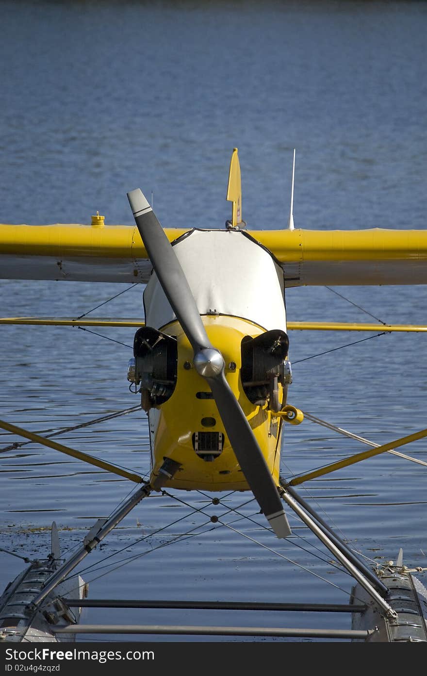 A yellow water plane docked.