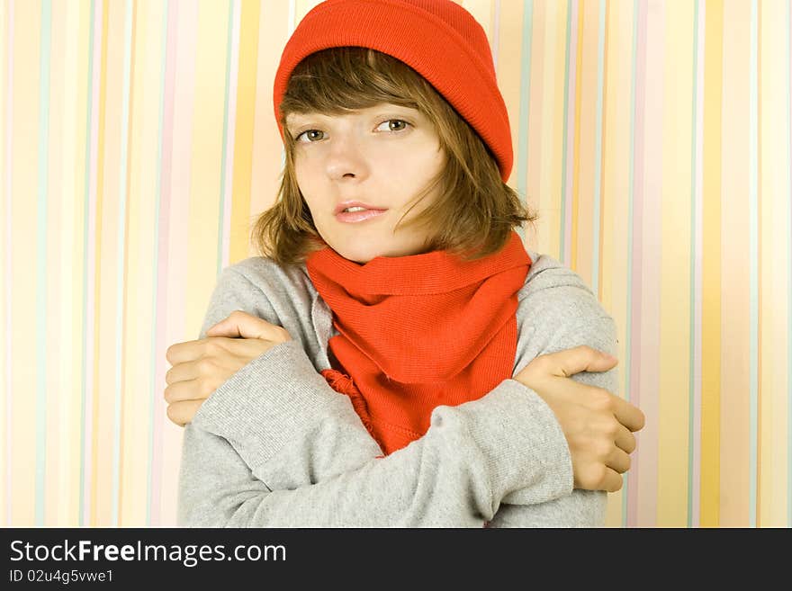 Photo of a young woman in a gray bike with a red knitted hat and scarf. Freezes. Photo of a young woman in a gray bike with a red knitted hat and scarf. Freezes