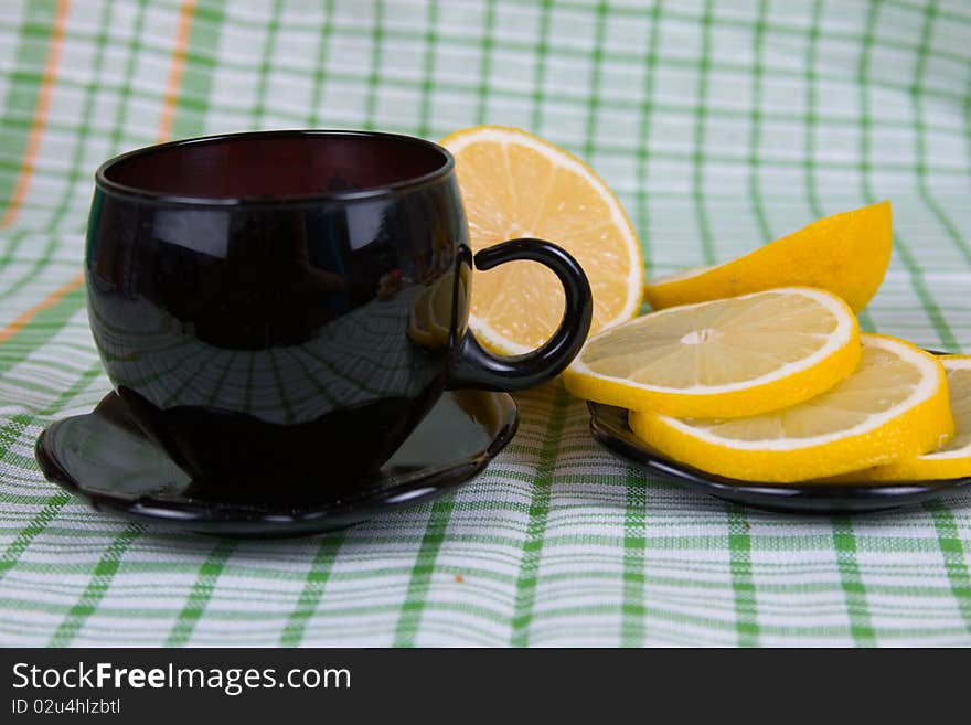 Tea with lemon on a green napkin