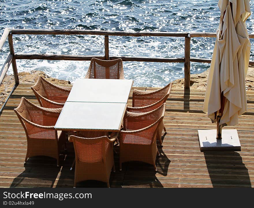 Table and chairs on a terrace overlooking the island Crete. Table and chairs on a terrace overlooking the island Crete