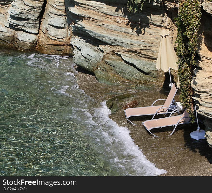 Wo beach beds under umbrella on a private beach in crete. Wo beach beds under umbrella on a private beach in crete