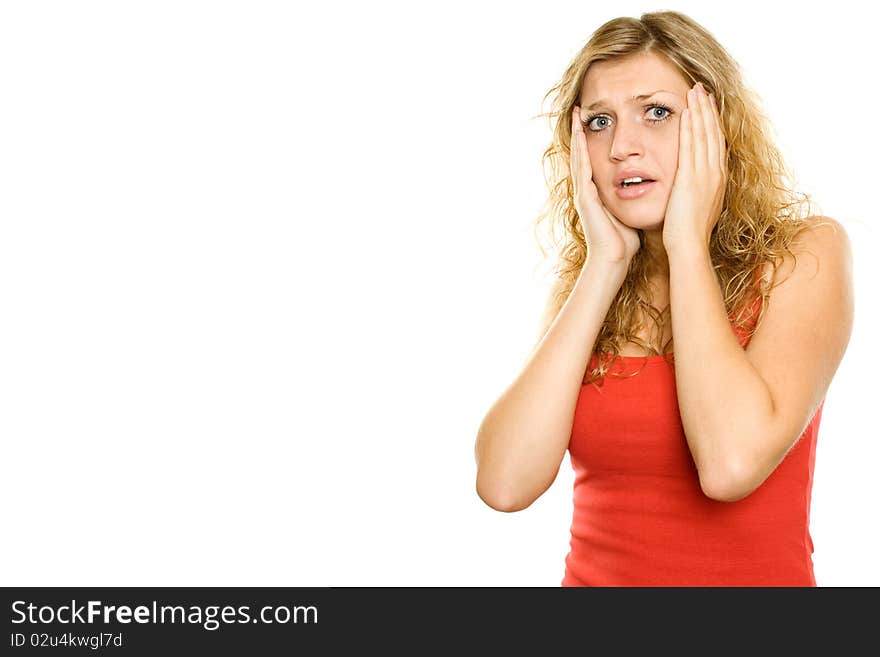 Close-up of a young woman looking surprised. Hands on cheeks. Lots of copyspace and room for text on this isolate. Close-up of a young woman looking surprised. Hands on cheeks. Lots of copyspace and room for text on this isolate