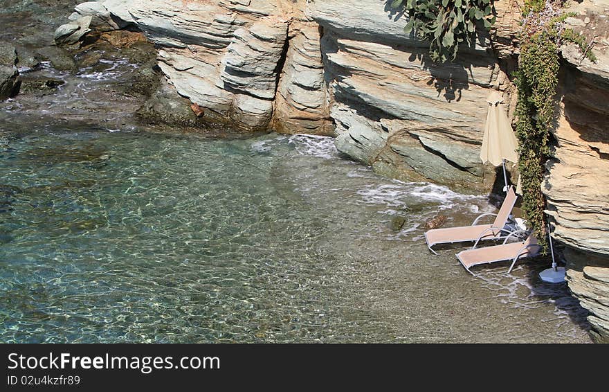 Two beach beds under umbrella on beach. Two beach beds under umbrella on beach