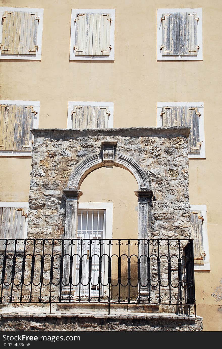 Stone arc, old yellow wall and windows with shutters(Italy). Stone arc, old yellow wall and windows with shutters(Italy)