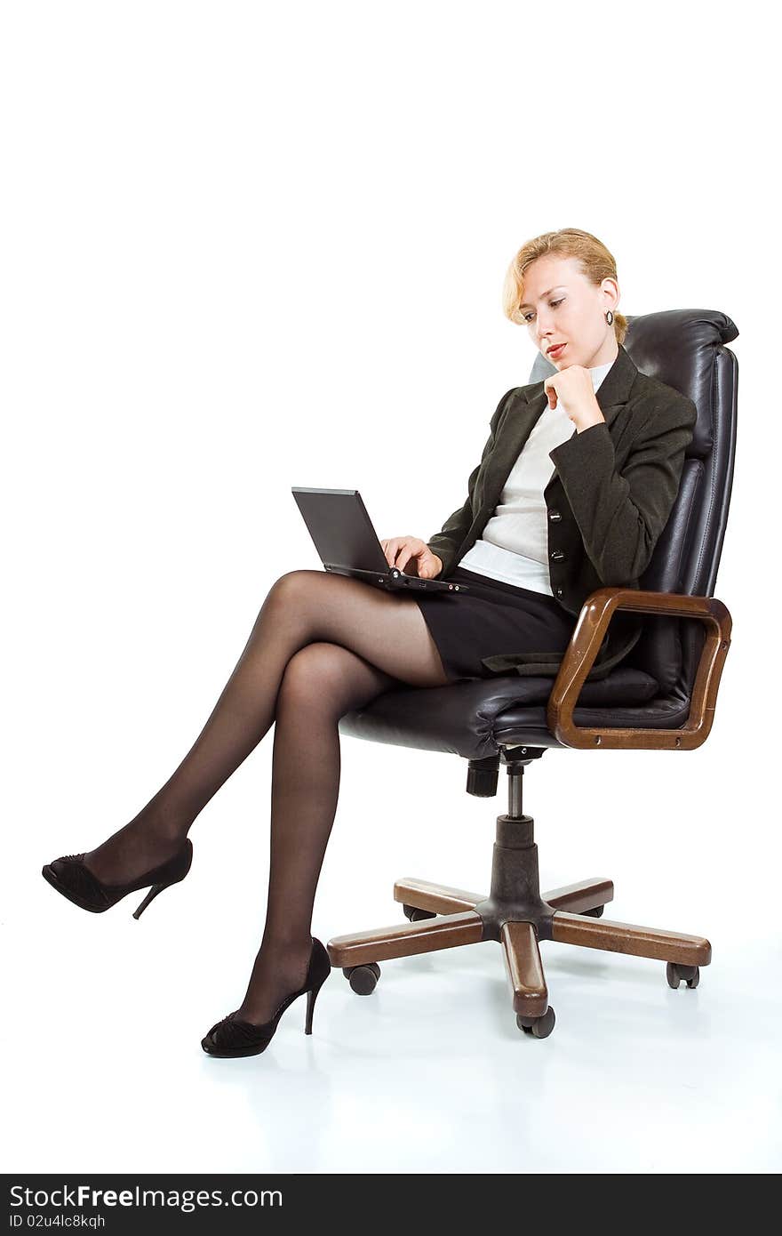 Business woman with laptop sitting in a chair