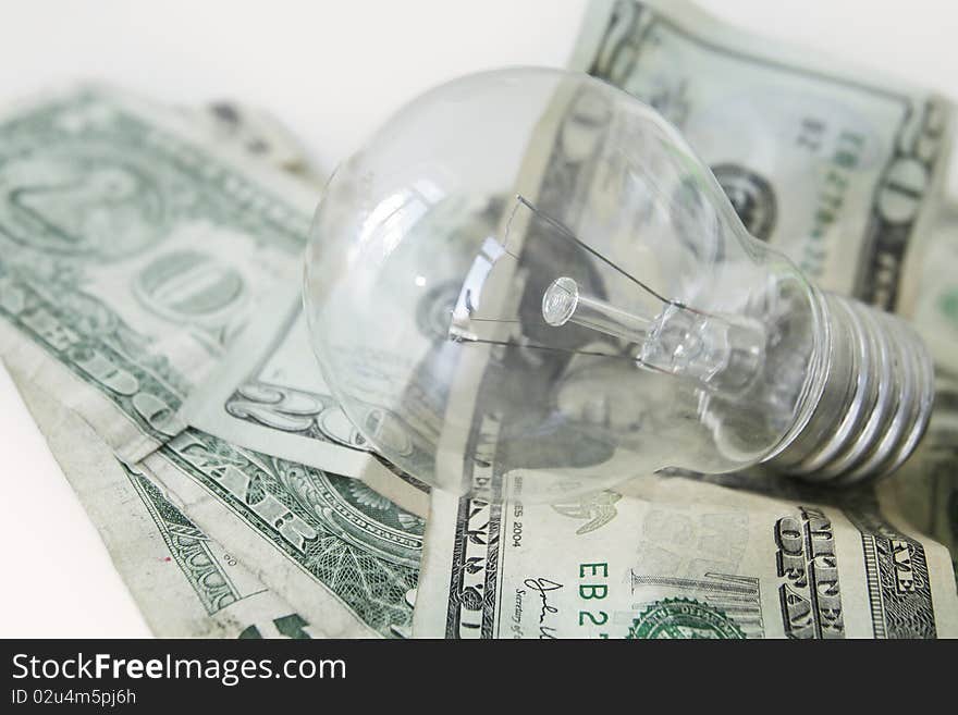 Lightbulb and dollar notes isolated. Lightbulb and dollar notes isolated