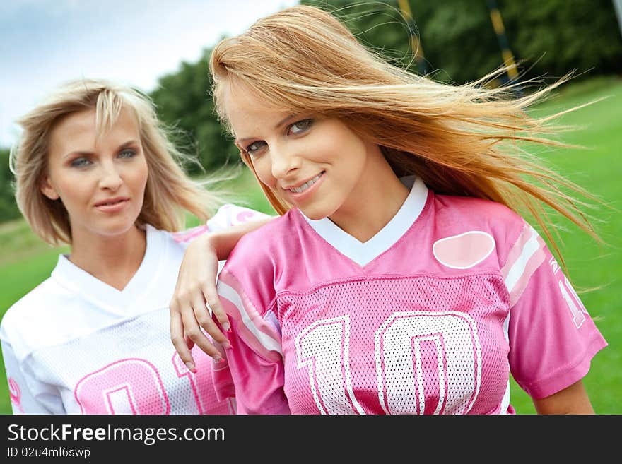 Two pretty girls on a sportsfield. Two pretty girls on a sportsfield