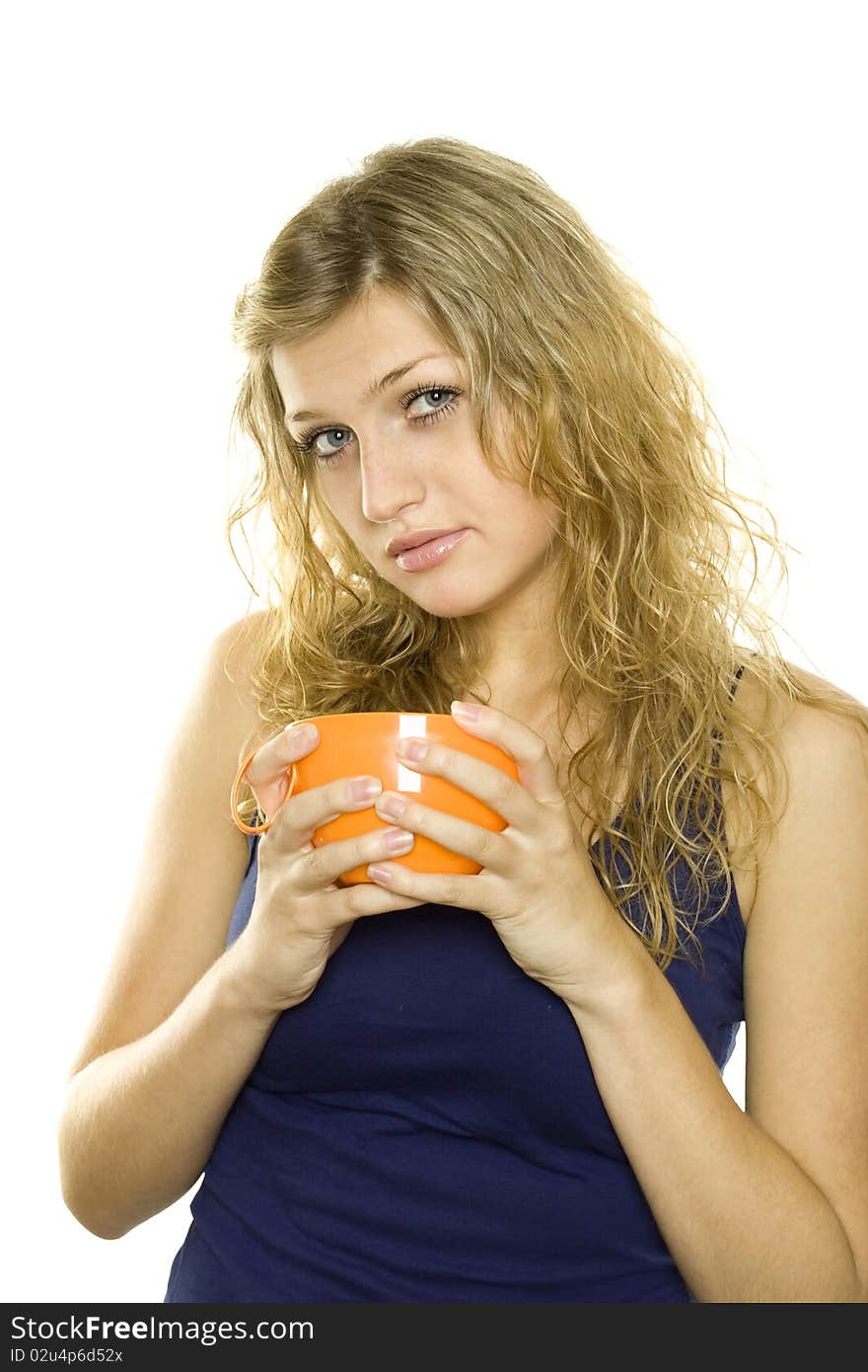 Pretty young woman with an orange cup of tea / coffee. Isolated on white background. Pretty young woman with an orange cup of tea / coffee. Isolated on white background