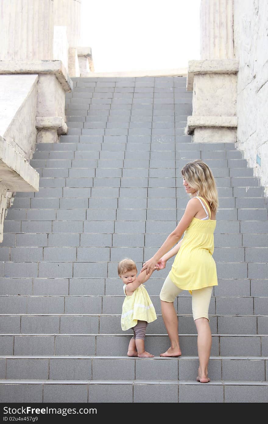 Mom and daughter climb the stairs