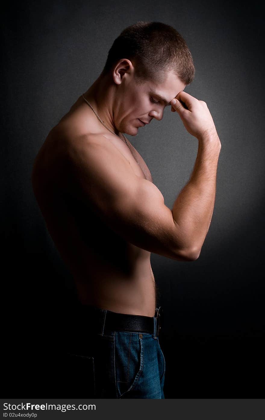 Strong athletic man on black background