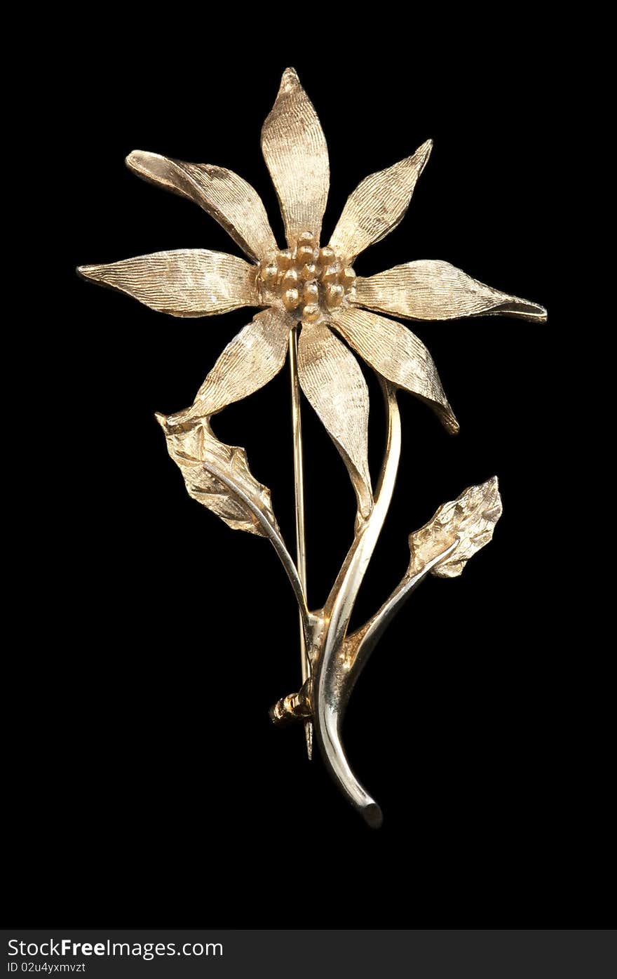 Vintage golden flower brooch isolated on a black background