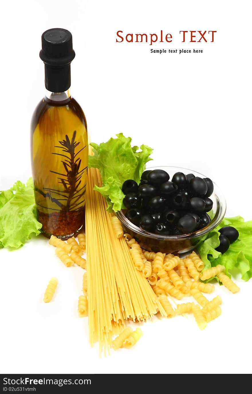 A bottle of olive oil with pasta and black olives isolated on a white background.