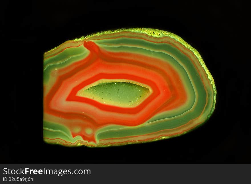 Colorful enigmatic geode stone from Germany at black background