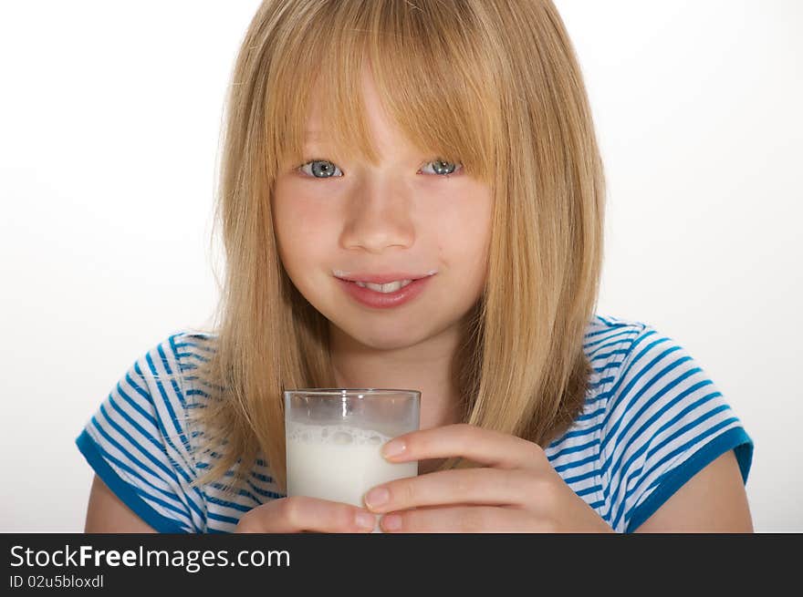 Young girl drinking a glass of milk. Young girl drinking a glass of milk