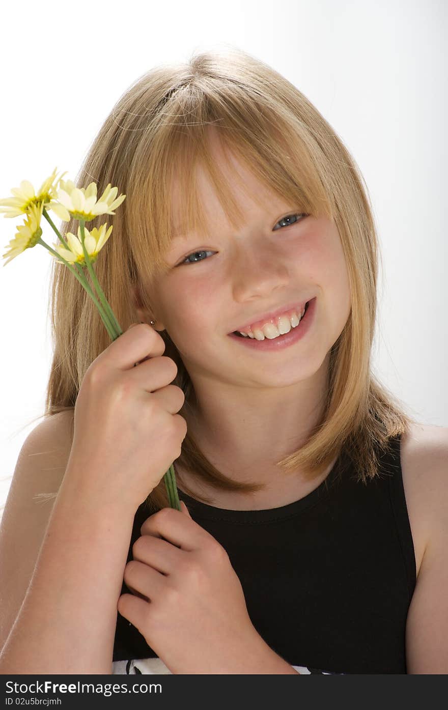 Young girl smiling and holding a bunch of daisies. Young girl smiling and holding a bunch of daisies