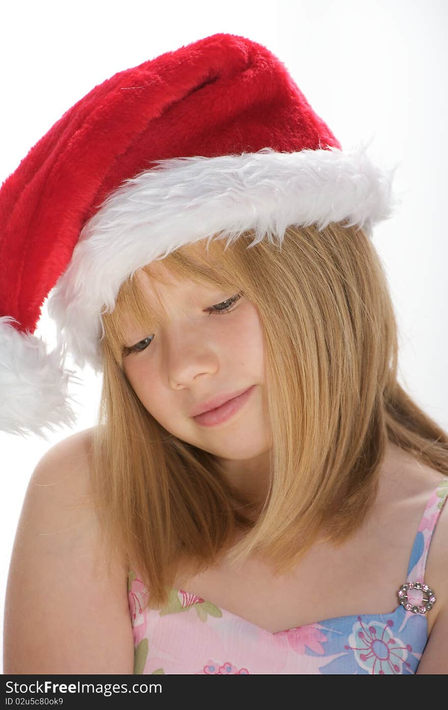 Young girl smiling and wearing a santa hat. Young girl smiling and wearing a santa hat