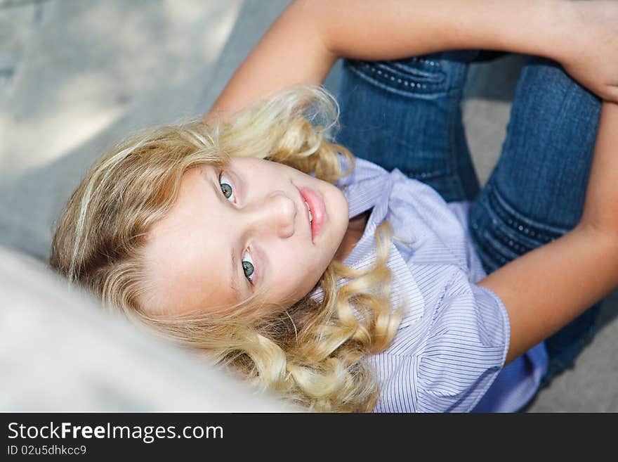 Teenage girl sits on stairs and looks up. Teenage girl sits on stairs and looks up