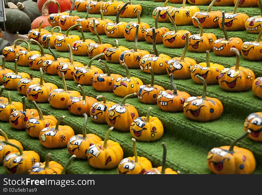 Rows of comical painted gourds