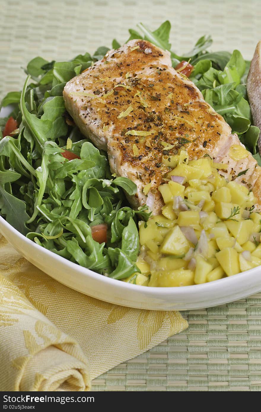 Grilled atlantic salmon fish on salad. Fruit salsa on the side. Very sharp. . Grilled atlantic salmon fish on salad. Fruit salsa on the side. Very sharp.