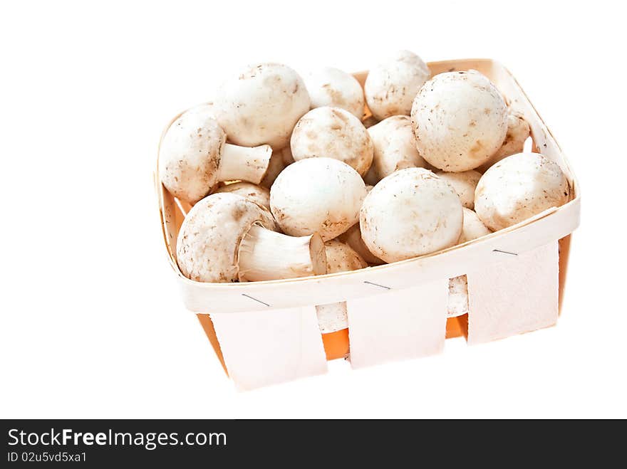 Raw mushrooms in box on white background