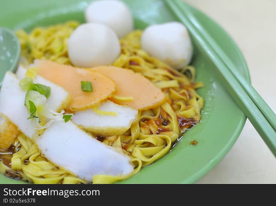 Sumptuous looking Oriental fishball noodles with generous toppings of fishballs and fish cake. Suitable for concepts such as food and beverage, and travel and cuisine.