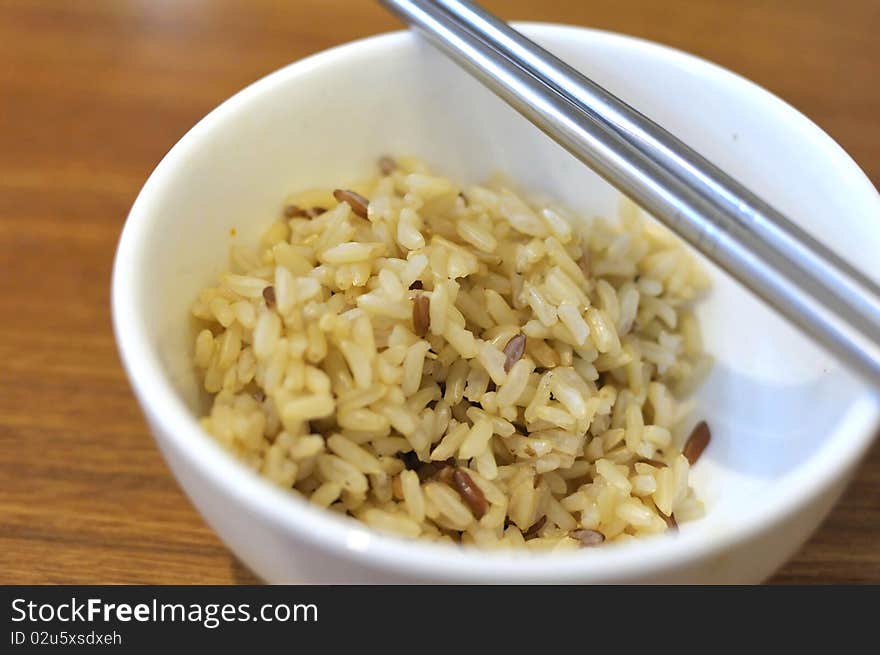 Cooked, red unpolished rice commonly eaten in Asian countries such as Japan and China. For diet and nutrition, healthy eating and lifestyle concepts.