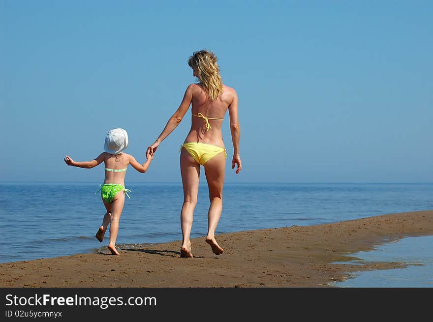 Mother with child have fun on the beach. Mother with child have fun on the beach