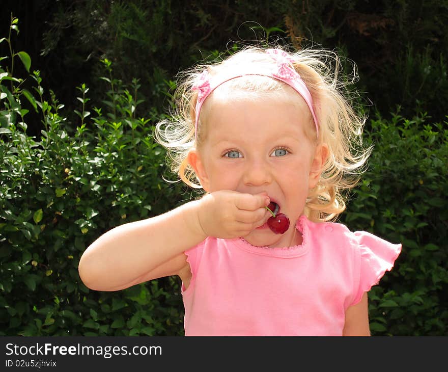 Little Girl Eats Cherry