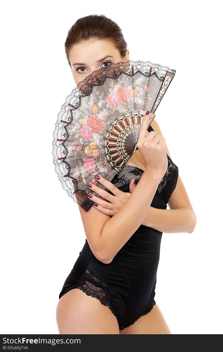 Young fashion model posing in underwear with a folding fan isolated on white