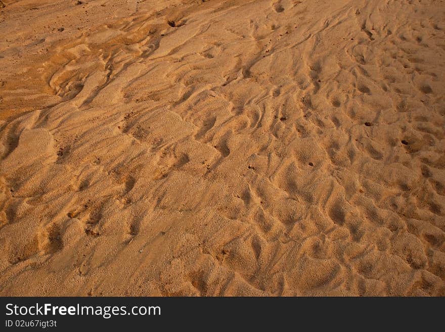 The brown sand is lined with beautiful waves taken from the beach beside the river in Thailand. The brown sand is lined with beautiful waves taken from the beach beside the river in Thailand