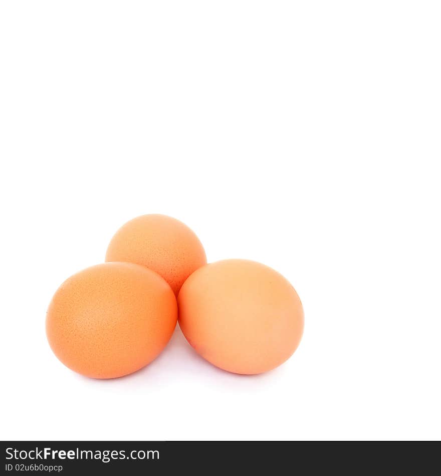 Three chicken eggs on a white background