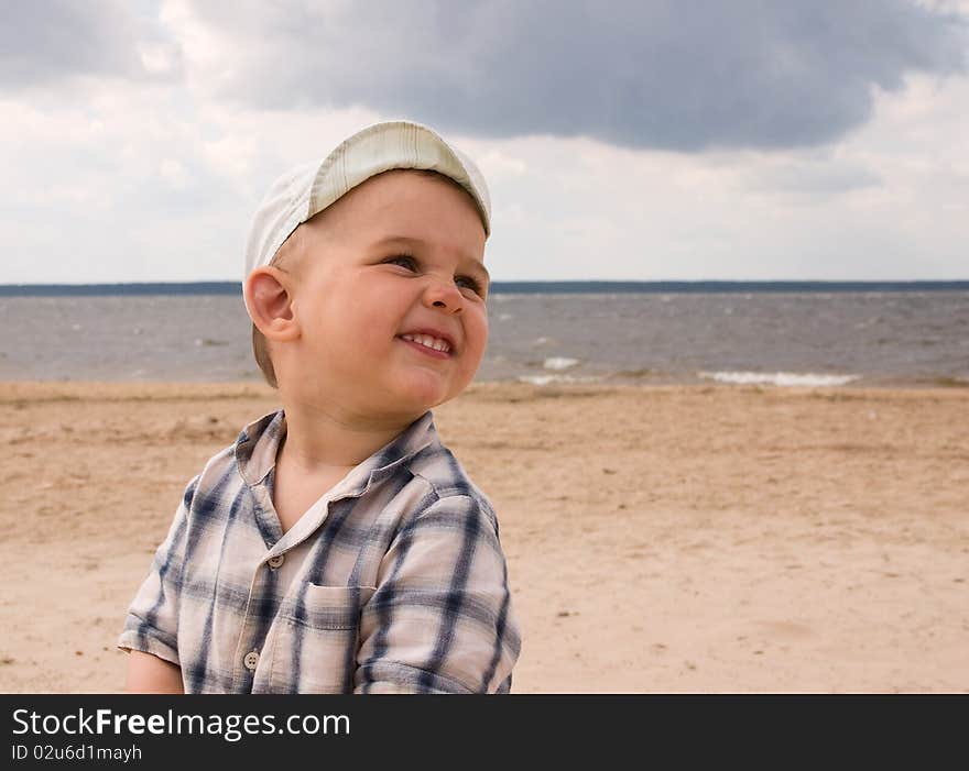 Smiling boy play on a beach. Smiling boy play on a beach