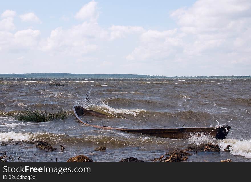 Old boat near lake coast