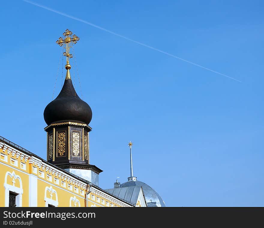 Vapor trail supersonic fighter jet over the monastery