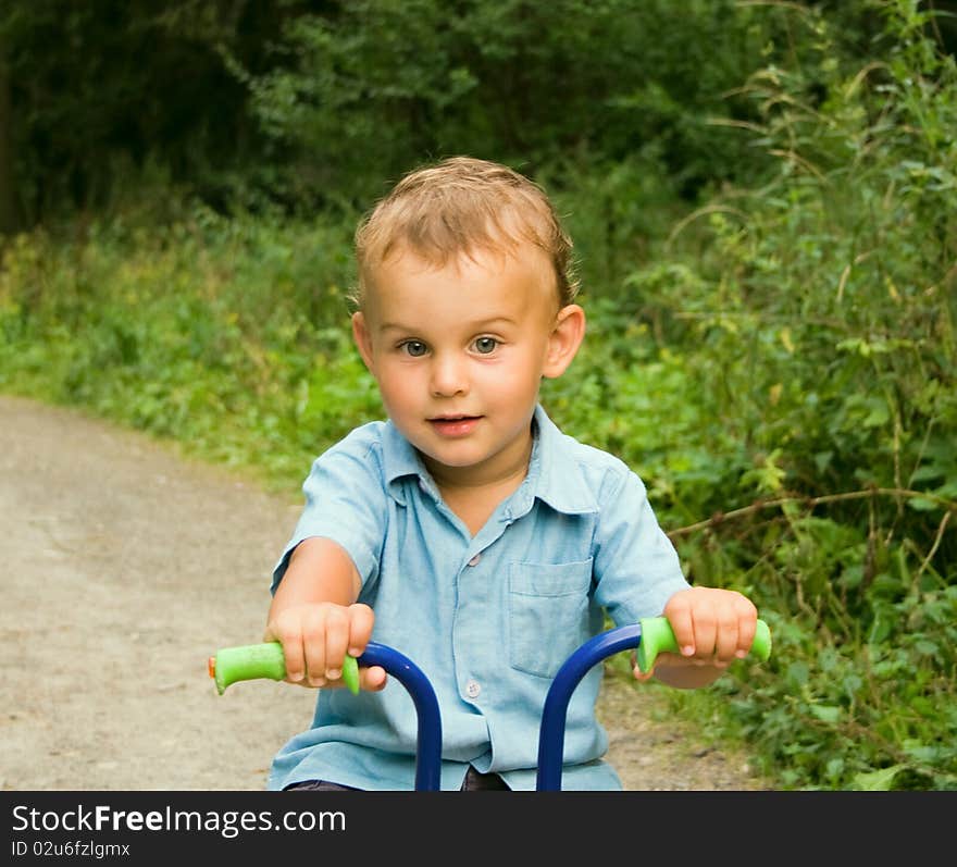 Boy riding bicycle in forest. Boy riding bicycle in forest