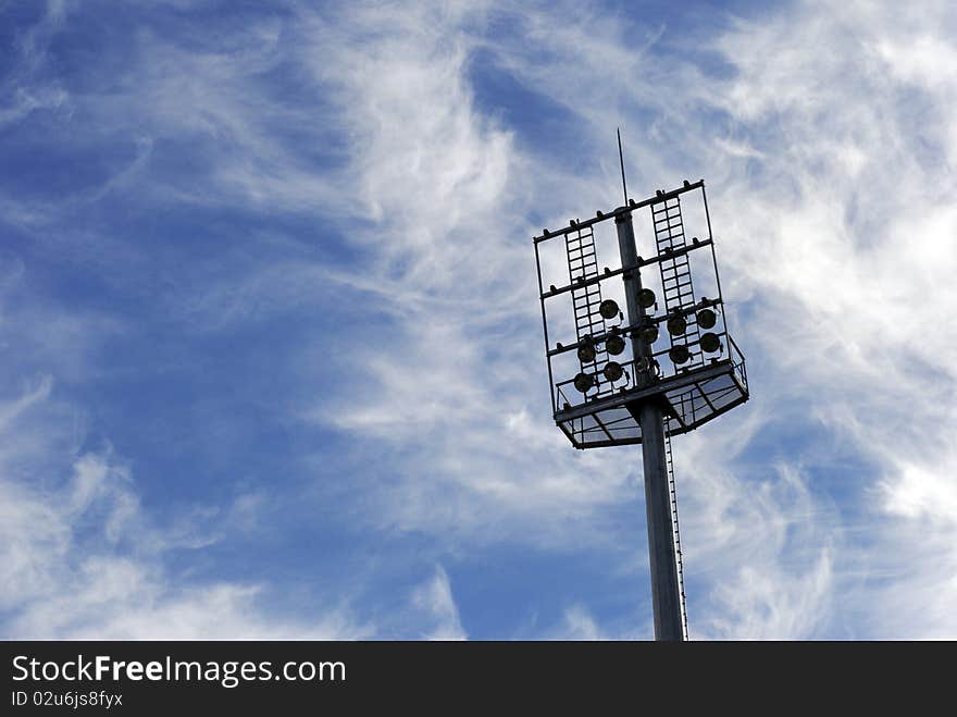 Soccer stadium floodlights. View from below against a summer sunset sky. Soccer stadium floodlights. View from below against a summer sunset sky.