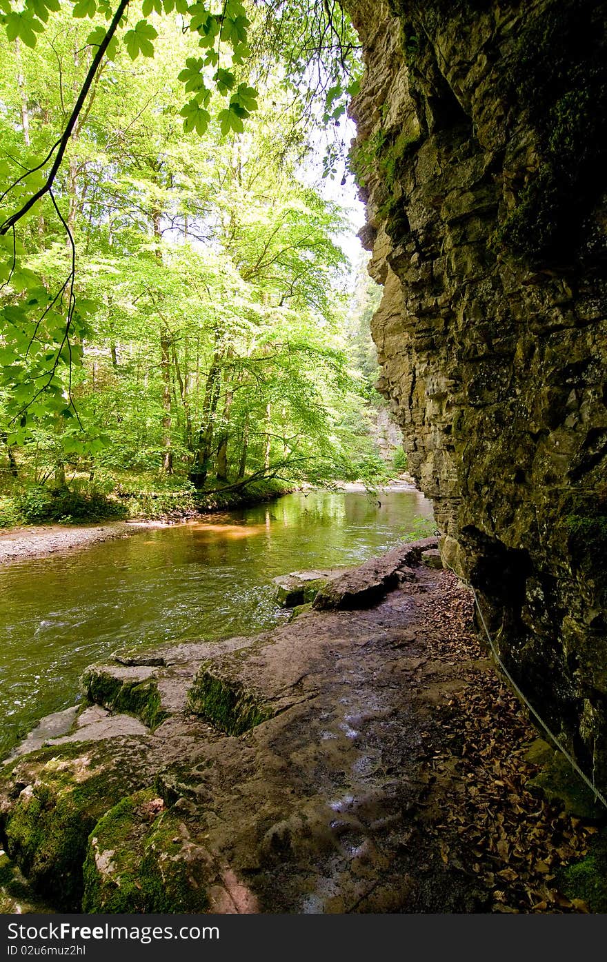 Alongside the river under rocks on stony trails. Alongside the river under rocks on stony trails