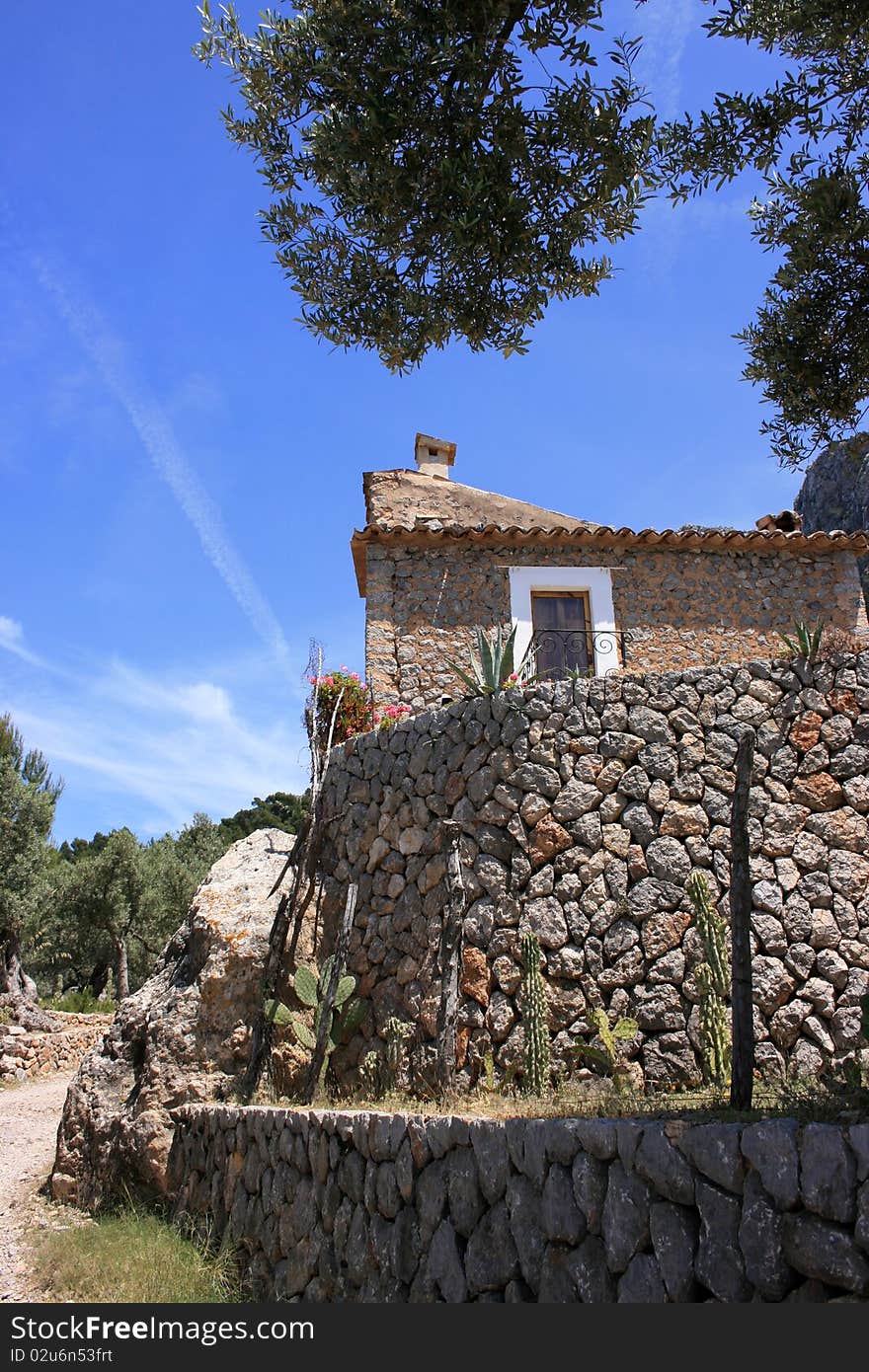 Smal finca with stone wall in sierra de tramuntana near soller, mallorca