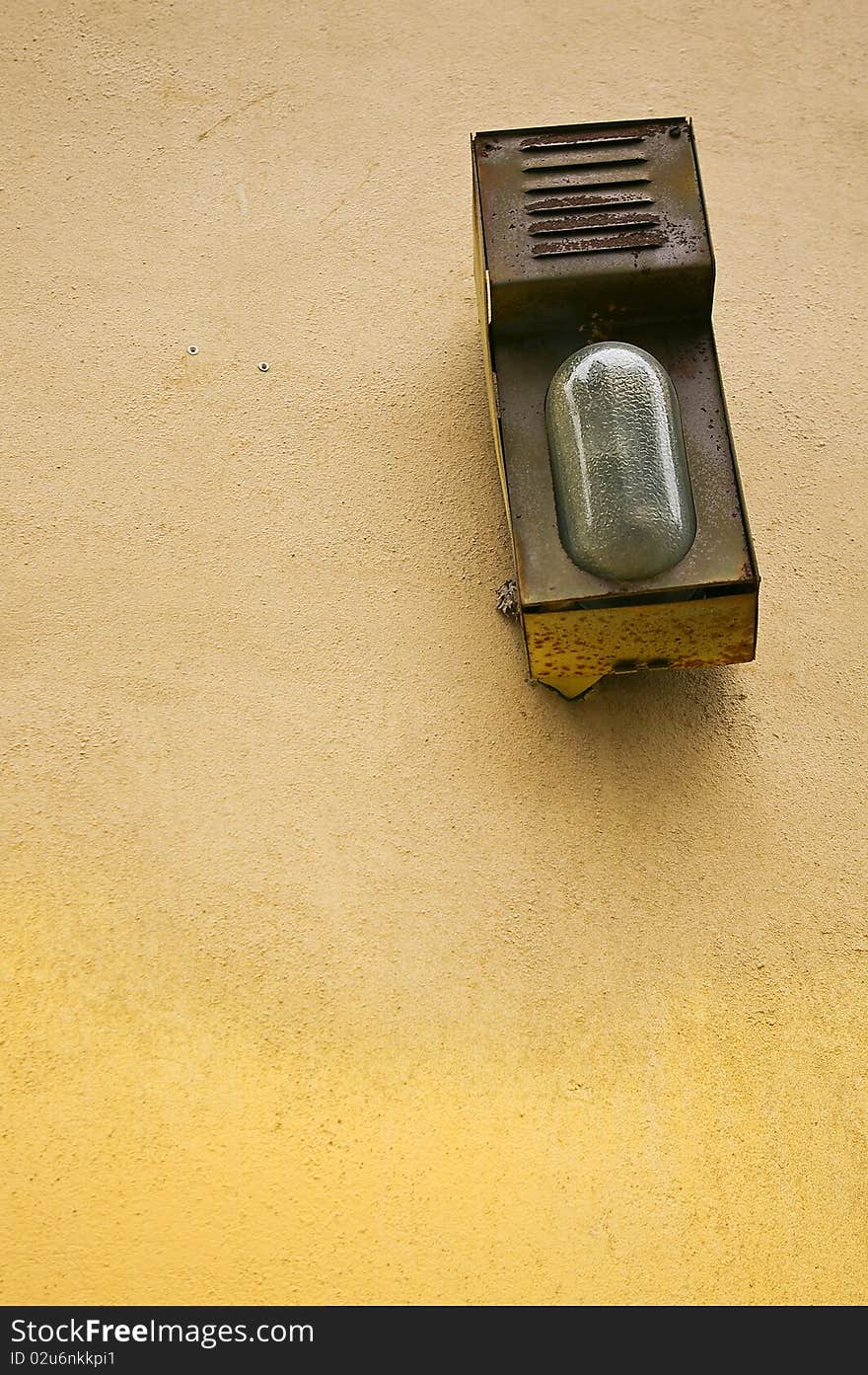 Alarmsystem on a yellow plastered wall