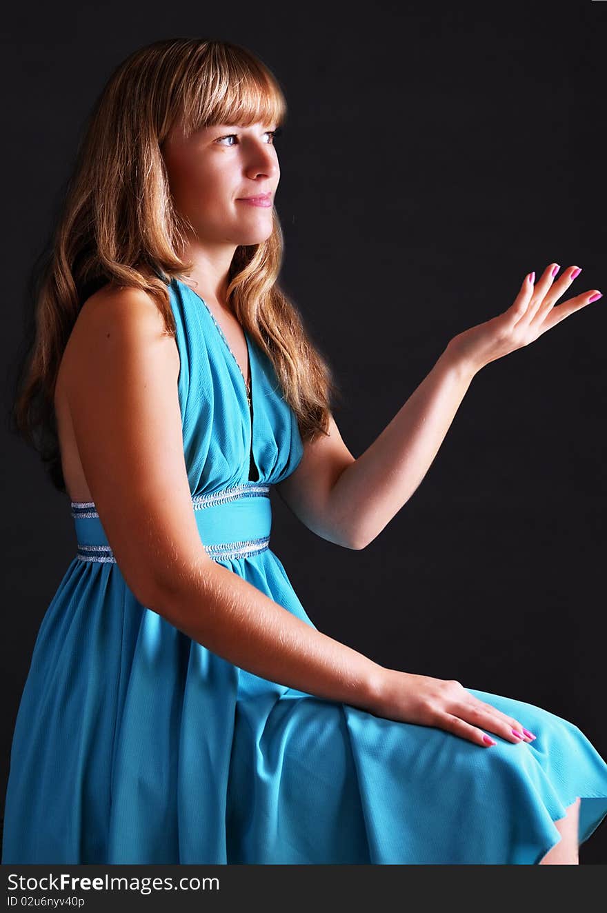 Portrait of the young girl on a dark grey background